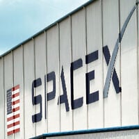 A SpaceX logo is displayed on a building, May 26, 2020, at the Kennedy Space Center in Cape Canaveral, Florida. (AP Photo/David J. Phillip)