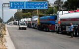 Iraqi trucks loaded with oil wait to drive toward the Baniyas oil refinery along a highway in Tartus Governorate, western Syria, May 1, 2026. (AP/Omar Sanadiki)