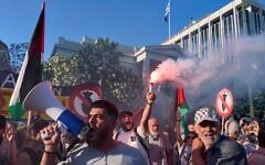 A protester holds a flare as others chant pro-Palestinian slogans outside Greece’s Foreign Ministry after Israel’s navy intercepted an activists flotilla in waters off of Cyprus, in Athens on May 18, 2026. (AP Photo/Petros Giannakouris)