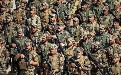FILE: Members of the Saraya al-Salam Shiite militia attend a ceremony marking the start of the process of handing over their weapons to Iraqi state forces in Samarra, north of Baghdad, Iraq, June 4, 2026. (AP Photo/Anmar Khalil)
