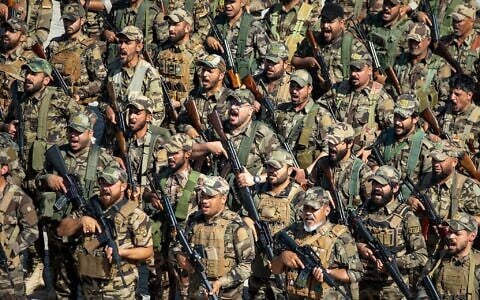 FILE: Members of the Saraya al-Salam Shiite militia attend a ceremony marking the start of the process of handing over their weapons to Iraqi state forces in Samarra, north of Baghdad, Iraq, June 4, 2026. (AP Photo/Anmar Khalil) FILE: Members of the Saraya al-Salam Shiite militia attend a ceremony marking the start of the process of handing over their weapons to Iraqi state forces in Samarra, north of Baghdad, Iraq, June 4, 2026. (AP Photo/Anmar Khalil)