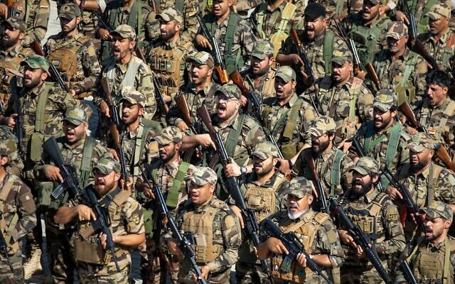 Members of the Saraya al-Salam Shiite militia attend a ceremony marking the start of the process of handing over their weapons to Iraqi state forces in Samarra, north of Baghdad, Iraq, June 4, 2026. (AP Photo/Anmar Khalil)