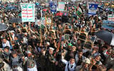 Houthi supporters raise their leader Abdul Malik al-Houthi posters during a rally titled, “denouncing the Zionist criminal Trump’s insult toward Mecca” in Sanaa, Yemen, June 16, 2026. (AP Photo/Osamah Abdulrahman)