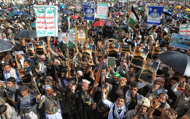 Houthi supporters raise their leader Abdul Malik al-Houthi posters during a rally titled, “denouncing the Zionist criminal Trump’s insult toward Mecca” in Sanaa, Yemen, June 16, 2026. (AP Photo/Osamah Abdulrahman)