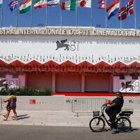 Festivalgoers pass the red carpet of the 81st edition of the Venice Film Festival in Venice, Italy, August 27, 2024. (Vianney Le Caer/Invision/AP)