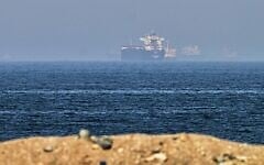 Cargo ships are seen at sea near the Strait of Hormuz, as viewed from a rocky shoreline near Khor Fakkan, United Arab Emirates, May 1, 2026. (AP Photo/Fatima Shbair)
