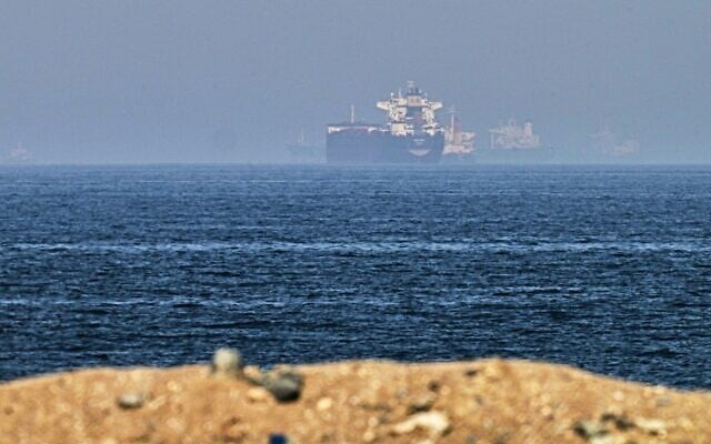 Cargo ships are seen at sea near the Strait of Hormuz, as viewed from a rocky shoreline near Khor Fakkan, United Arab Emirates, May 1, 2026. (AP Photo/Fatima Shbair)