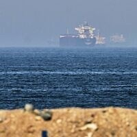 Cargo ships are seen at sea near the Strait of Hormuz, as viewed from a rocky shoreline near Khor Fakkan, United Arab Emirates, May 1, 2026. (AP Photo/Fatima Shbair)