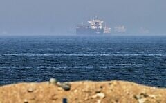 Cargo ships are seen at sea near the Strait of Hormuz, as viewed from a rocky shoreline near Khor Fakkan, United Arab Emirates, May 1, 2026. (AP Photo/Fatima Shbair)