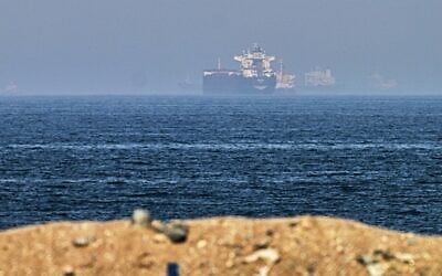 Cargo ships are seen at sea near the Strait of Hormuz, as viewed from a rocky shoreline near Khor Fakkan, United Arab Emirates, May 1, 2026. (AP Photo/Fatima Shbair)