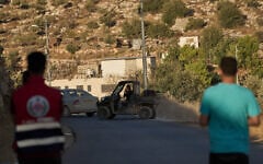 FILE: Palestinians observe the movement of Israeli settlers in an area in the West Bank of village of Abu Falah, July 29, 2026. (AP Photo/Leo Correa)