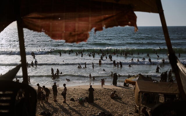 Palestinians cool off in the Mediterranean Sea during a heatwave in Nuseirat, central Gaza Strip, July 30, 2026. (AP Photo/Abdel Kareem Hana)