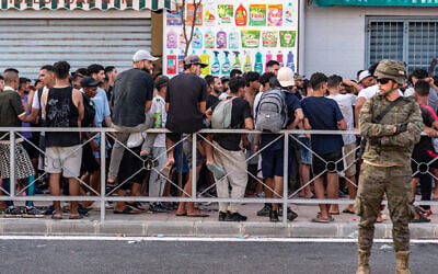Migrants wait for a shop to open so they can buy food after crossing from Morocco into the Spanish enclave of Ceuta, July 31, 2026. (AP Photo/Antonio Sempere) Migrants wait for a shop to open so they can buy food after crossing from Morocco into the Spanish enclave of Ceuta, July 31, 2026. (AP Photo/Antonio Sempere)