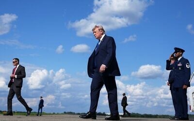 US President Donald Trump, center, walks from Air Force One at Morristown Municipal Airport in Morristown, New Jersey, July 31, 2026, from Camp David, the presidential retreat. (AP Photo/Jacquelyn Martin) US President Donald Trump, center, walks from Air Force One at Morristown Municipal Airport in Morristown, New Jersey, July 31, 2026, from Camp David, the presidential retreat. (AP Photo/Jacquelyn Martin)