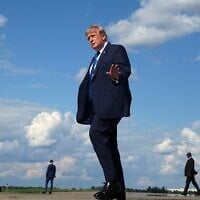 US President Donald Trump waves as he walks from Air Force One at Morristown Municipal Airport in Morristown, New Jersey, July 31, 2026, from Camp David, the presidential retreat. (AP Photo/Jacquelyn Martin)