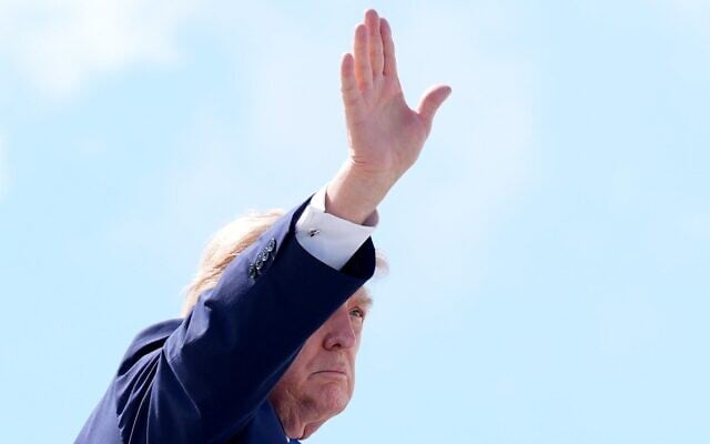 US President Donald Trump waves as he boards Air Force One in Hagerstown, Maryland, July 31, 2026, after attending a cabinet meeting at Camp David, the presidential retreat. (AP Photo/Jacquelyn Martin)