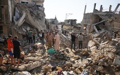 Palestinians inspect destroyed buildings at the scene of an Israeli airstrike, at al-Maghazi refugee camp, central Gaza Strip, August 1, 2026. (AP/Abdel Kareem Hana) Palestinians inspect destroyed buildings at the scene of an Israeli airstrike, at al-Maghazi refugee camp, central Gaza Strip, August 1, 2026. (AP/Abdel Kareem Hana)