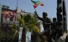A statue of Palestinians stands with Iranian flag as a banner shows newly elected Hamas leader Khalil al-Hayya, center, alongside the late leaders Ismail Haniyeh, right, and Yahya Sinwar, with writing in Hebrew reads: “From Sinwar’s generation, the new leader on the ground” and in Arabic: “Khalil al-Hayya, the occupiers’ nightmare” at Palestine square in downtown Tehran, Iran, August 1, 2026. (AP Photo/Vahid Salemi)