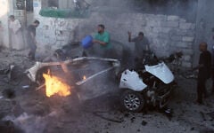 Palestinians try to extinguish a burning car after an Israeli military strike in Gaza City, August 2, 2026. (AP Photo/Jehad Alshrafi)