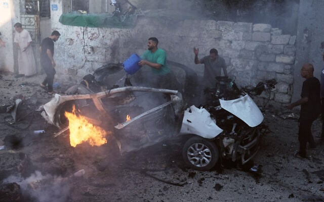 Palestinians try to extinguish a burning car after an Israeli military strike in Gaza City, August 2, 2026. (AP Photo/Jehad Alshrafi)