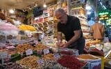 A shopkeeper arranges nuts at his shop at Tajrish traditional bazaar in northern Tehran, Iran, August 2, 2026. (AP Photo/Vahid Salemi)