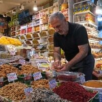 A shopkeeper arranges nuts at his shop at Tajrish traditional bazaar in northern Tehran, Iran, August 2, 2026. (AP Photo/Vahid Salemi)