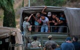 Migrants who crossed into Spain are escorted by Spanish soldiers towards the Spanish-Moroccan border for their return to Morocco from the Spanish enclave of Ceuta, August 2, 2026. (AP Photo/Antonio Sempere)