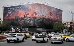 A billboard depicting a fallen Statue of Liberty and crowds carrying Iranian and Shiite flags overlooks Revolution Square as traffic drives by in Tehran, Iran, August 3, 2026. (AP Photo/Vahid Salemi)