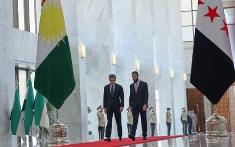 Syrian President Ahmad al-Sharaa, right, walks with Kurdistan Region President Nechirvan Barzani during a meeting at the People’s Palace in Damascus, Syria, August 3, 2026. (AP Photo/Ghaith Alsayed)