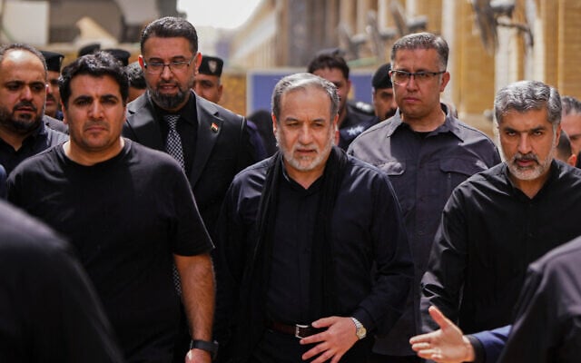 Iranian Foreign Minister Abbas Araghchi, center, is surrounded by security personnel as he walks during the Arbaeen commemoration in Najaf, Iraq, August 3, 2026. (AP Photo/Anmar Khalil)