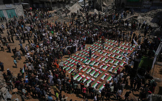 Bodies of members of the Hassayna and Abu Sharia families, allegedly killed in an Israeli strike in 2023 and recently recovered from the rubble, are draped in Palestinian flags during their funeral in Gaza City, August 4, 2026. (AP Photo/Jehad Alshrafi)