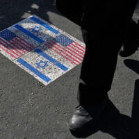 Illustrative: US and Israeli flags are pasted on the ground in Tehran, Iran, August 4, 2026. (AP Photo/Vahid Salemi)