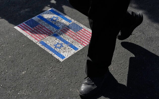 Illustrative: US and Israeli flags are pasted on the ground in Tehran, Iran, August 4, 2026. (AP Photo/Vahid Salemi)