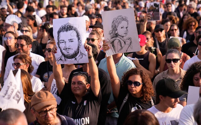 Relatives of victims of the 2020 Beirut port explosion, hold up portraits of their loved ones during a memorial ceremony marking the sixth anniversary of the massive blast in Beirut, Lebanon, August 4, 2026. (AP Photo/Hussein Malla)
