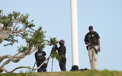 Members of the US Secret Service watch before Marine One with US President Donald Trump aboard, lands near Trump National Golf Club Los Angeles, August 4, 2026, in Rancho Palos Verdes, Calif. (AP Photo/Mark Schiefelbein)