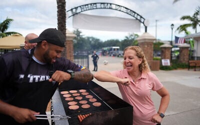 Rep. Debbie Wasserman Schultz, D-Florida, greets a man tending to a grill as she visits a National Night Out community event while campaigning for Florida’s 20th congressional district, in Plantation, Florida, August 4, 2026. Rep. Debbie Wasserman Schultz, D-Florida, greets a man tending to a grill as she visits a National Night Out community event while campaigning for Florida’s 20th congressional district, in Plantation, Florida, August 4, 2026.