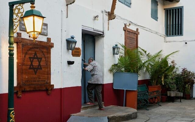 Keith Hallegua, a Paradesi Jew, opens the door to enter the 458-year-old Paradesi Synagogue in the historic Jew Town neighborhood of Kochi, India, May 21, 2026. (AP Photo/Aijaz Rahi)