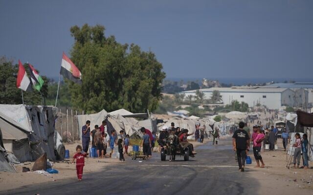 Palestinians go about their daily activities at a makeshift camp for displaced people in Deir al-Balah, central Gaza Strip, August 7, 2026. (AP Photo/Abdel Kareem Hana)