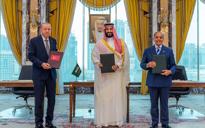 From left, Turkish President Recep Tayyip Erdogan, Saudi Crown Prince Mohammed bin Salman and Pakistani Prime Minister Shehbaz Sharif pose after signing a trilateral defense agreement in Mecca, Saudi Arabia, August 7, 2026. (Saudi Press Agency via AP)