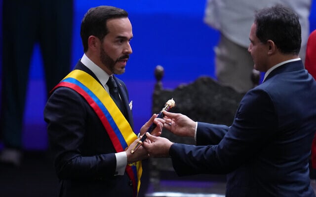 Colombian President Abelardo de la Espriella receives the ceremonial staff from Senate President Honorio Henriquez during his inauguration in Cali, Colombia, August 7, 2026. (AP Photo/Matias Delacroix)
