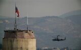 A Russian helicopter flies over the Hmeimim Air Base located southeast of the city of Latakia in the town of Hmeimim, Syria, December 16, 2024. (AP Photo/Leo Correa)