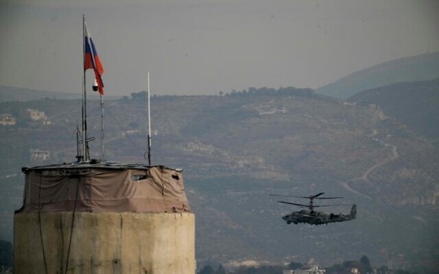 A Russian helicopter flies over the Hmeimim Air Base located southeast of the city of Latakia in the town of Hmeimim, Syria, December 16, 2024. (AP Photo/Leo Correa)
