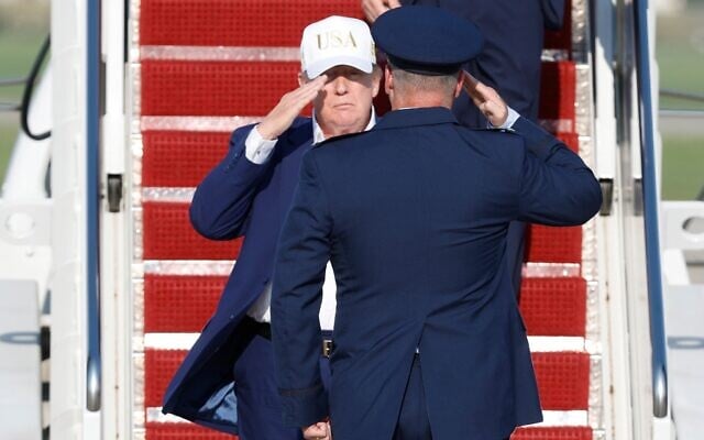 US President Donald Trump, left, is greeted by Air Force Col. Christopher M. Robinson, commander, 89th Airlift Wing after walking down the stairs of Air Force One, upon his arrival at Joint Base Andrews, Maryland, August 9, 2026. (AP Photo/Luis M. Alvarez) US President Donald Trump, left, is greeted by Air Force Col. Christopher M. Robinson, commander, 89th Airlift Wing after walking down the stairs of Air Force One, upon his arrival at Joint Base Andrews, Maryland, August 9, 2026. (AP Photo/Luis M. Alvarez)