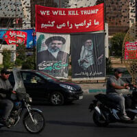 Vehicles drive past a banner reading in English and Farsi, 'We will kill Trump,' and banners showing portraits of the late Iranian supreme leader ayatollah Ali Khamenei, right, and his son Ayatollah Mojtaba Khamenei, in Tehran, Iran, August 10, 2026. (AP/Vahid Salemi)
