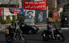 Vehicles drive past a banner reading in English and Farsi, 'We will kill Trump,' and banners showing portraits of the late Iranian supreme leader ayatollah Ali Khamenei, right, and his son Ayatollah Mojtaba Khamenei, in Tehran, Iran, August 10, 2026. (AP/Vahid Salemi)