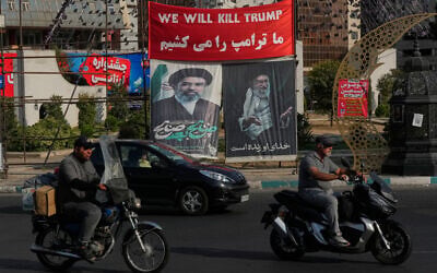 Vehicles drive past a banner reading in English and Farsi, 'We will kill Trump,' and banners showing portraits of the late Iranian supreme leader ayatollah Ali Khamenei, right, and his son Ayatollah Mojtaba Khamenei, in Tehran, Iran, August 10, 2026. (AP/Vahid Salemi) Vehicles drive past a banner reading in English and Farsi, 'We will kill Trump,' and banners showing portraits of the late Iranian supreme leader ayatollah Ali Khamenei, right, and his son Ayatollah Mojtaba Khamenei, in Tehran, Iran, August 10, 2026. (AP/Vahid Salemi)