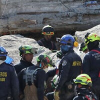 Rescue workers search through the rubble of a collapsed building the day after an earthquake struck Cali, Colombia, August 11, 2026. (AP Photo/Santiago Saldarriaga)