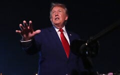 US President Donald Trump talks to reporters after arriving on Air Force One August 11, 2026, at Joint Base Andrews, Maryland. (AP Photo/Mark Schiefelbein)