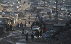 Palestinians walk among tents and rubble on the coastal road in Gaza City, in the Strip's north, on August 13, 2026. (AP Photo/Abdel Kareem Hana)