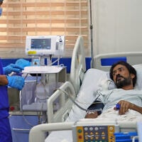 Pakistani crew member Zaheer Ahmed, right, receives medical treatment at 2 December Hospital in Mokha, Yemen, on August 12, 2026, after the cargo ship Tihama was struck in a Houthi attack in the Bab al-Mandab Strait off Yemen’s Dhubab district on August 10, 2026. (AP Photo/Abdulnasser Alseddik)
